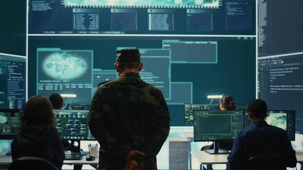 Military hackers working on cyber security in a high tech government center. Focusing on network protection, encryption and preventing cyber attacks to safeguard state secrets. Camera B. photo