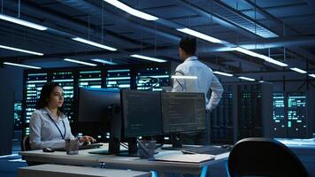 Data center agent providing logistics support to businesses and overseeing infrastructure. Server farm worker oversees hardware rackmounts and communicates with technicians, camera B photo