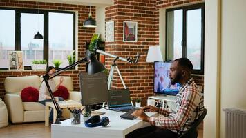 African american software engineer works on a laptop typing code for a development project. Technical specialist multitasking, debugging and using advanced digital tools for coding. Camera A. photo