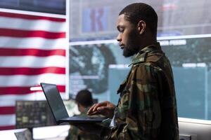 Military personnel in a control center operating advanced technology to ensure cybersecurity, managing surveillance systems and protecting classified data from cctv satellite. photo