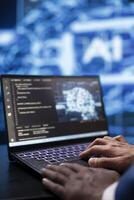 System administrator analyzing complex AI brain models on laptop. Close up shot of worker using machine learning on notebook device to develop artificial intelligence technology photo