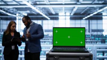 Isolated screen laptop in data center running error checking software monitoring hardware bugs. Close up of mockup notebook in server hub workspace checking for network issues, camera B photo