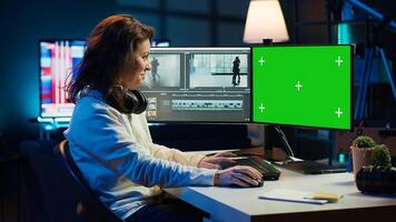 Woman using professional software on mockup PC to create visual effects for projects. Specialist using post production techniques to edit raw clips footage on green screen computer, camera A photo