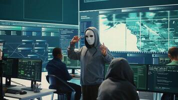 Governmental anonymous hackers group asking ransom for state secrets, important hacking activity during hybrid war. Recording a after stealing top secret information, big screen. Camera B. photo