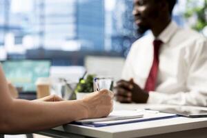 Talent acquisition expert reviewing candidate CV, asking questions about qualifications. Person getting hired for internship by employer after proving skills for financial business company job photo