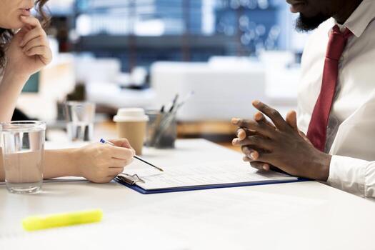 HR department worker reviewing candidate resume while asking questions about qualifications. Applicant at interview in office proving skills, showcasing expertise and enthusiasm for job opportunity photo