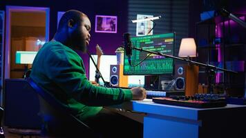Skilled composer writing rhymes and lyrics to create new music in home studio, thinking about harmonic notes and verses to compose cool songs. Songwriter producing soundtracks with gear. Camera B. photo