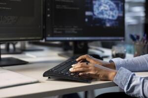 Engineer typing on keyboard in server hub, monitoring data center energy consumption using AI software. Close up of technician inspecting rackmounts in server room using artificial intelligence tech photo