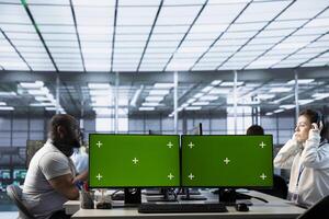 Engineer listening music, doing data center automation using machine learning on isolated screen computer. Woman wearing headphones integrating AI automation in server hub using chroma key PC photo