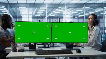 Green screen PC multi monitor setup in server hub workspace used to repair devices storing datasets. Chroma key computer used for servicing rigs doing computational operations, camera B photo