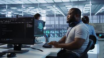 Teamworking colleagues updating AI systems, writing intricate binary code scripts on PC and laptop. Team of engineers using programming to upgrade artificial intelligence simulation model, camera B photo
