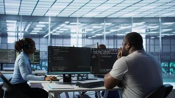 Sick IT professional in server hub sneezing while shielding data from potential threats using PC. Ill employee suffering from flu safeguarding data center against unauthorized access, camera B photo