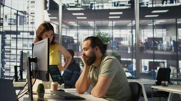 Fatigued software engineer caught asleep at desk by manager while developing artificial intelligence tech. Team leader waking up lazy worker while training predictive models, camera B photo