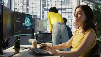 Admin tests on computer and tablet to optimize artificial intelligence machine learning models for performance and accuracy. IT worker in office analyzing and interpreting complex AI data, camera B photo