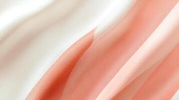 Soft flowing pink and white fabric with elegant wavy patterns highlighting texture photo