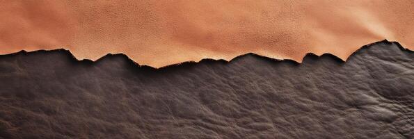 Textured brown and black leather surface with rough edge pattern for craft and design photo