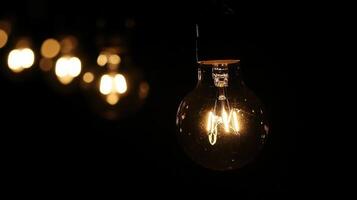 Glowing incandescent light bulbs against a dark background providing illumination photo