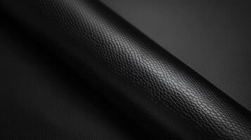 Textured black leather roll with reptile pattern for luxurious accessories design photo