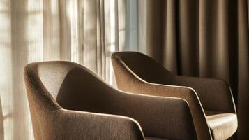 Elegant brown armchairs by sunlit window in cozy seating area photo