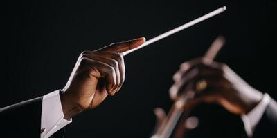 Orchestral Conductor s Hands with Baton Against Dark Background photo