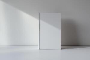 Minimalist Blank White Book on Clean Surface with Subtle Shadow Play photo