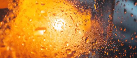Refreshing cold drink with condensation and ice in a warm atmosphere photo