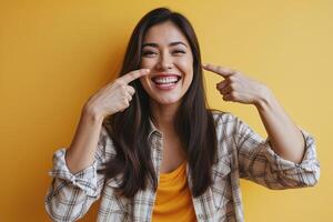 Portrait of Smiling Woman Gesturing towards Cheeks photo