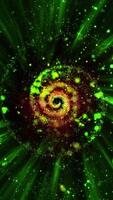 A green spiral galaxy, consisting of thousands of luminous particles, smoothly changes perspective, emitting streams of plasma into space. video