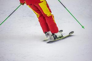 View of the person on the ski on the mountain slope photo
