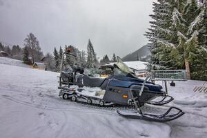 Snowmobile Parked in Winter the Wonderland photo