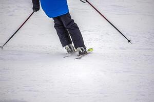 View of the ski boots on the ski on the mountain slope photo