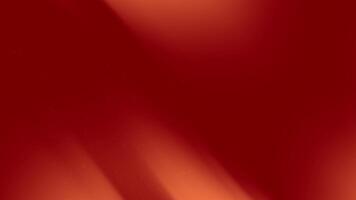 Red gradient background features subtle light streaks and small particles. video