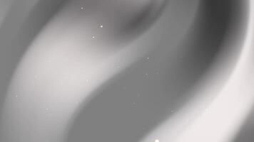 Grey background features subtle curves and small light specks. video
