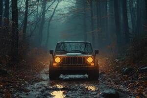Off-road vehicle driving on muddy road in misty forest at dusk photo