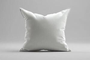 Single white square pillow resting on gray background. photo