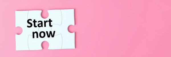 Begin your journey with a puzzle piece that says Start now on a pink background highlighting the essence of new beginnings photo