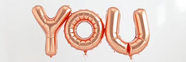 Decorated space featuring large rose gold letter balloons that spell you for a celebration or event setting photo