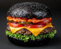 Close up of a delicious black burger with cheese, lettuce, tomato, and onion photo