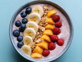 Healthy smoothie bowl with fresh fruit and granola. photo