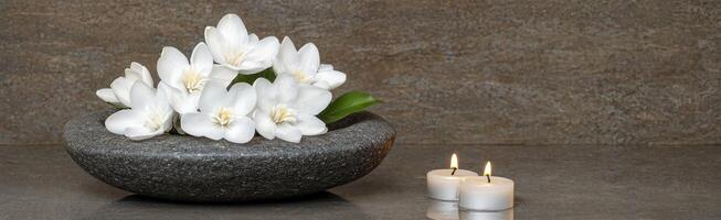 Spa like setting with white flowers and candles photo