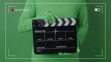Movie Clapper board clapped by Hands on green screen camera background. Filmmaker hit film slate on green camera frame. Clapperboard Chroma key suit shooting. Green screen. composite vdo production. video