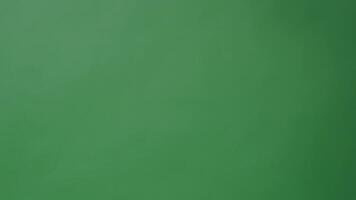 Movie Clapper board clapped by Hands. on green screen camera background. Filmmaker hit film slate on green camera frame. Clapperboard Chroma key suit shooting. Green screen composite vdo production. video