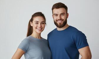 Smiling couple in blue t - shirts standing together photo