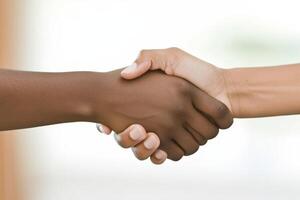 Two people shaking hands with each other photo