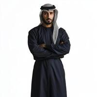 A man in an arabic outfit standing with his arms crossed photo