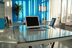 A glass desk with a laptop on it photo