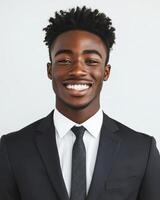 A young black man in a suit smiling photo