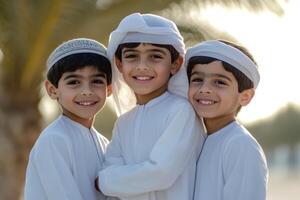 Three boys in traditional clothing pose for the camera photo