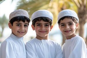 Three boys in traditional clothing pose for a photo