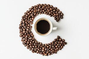 Coffee beans arranged in the shape of a letter c on a white background photo